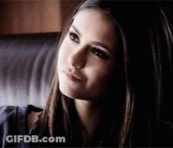 A Close Up Of A Woman 'S Face Sitting On A Couch . GIF