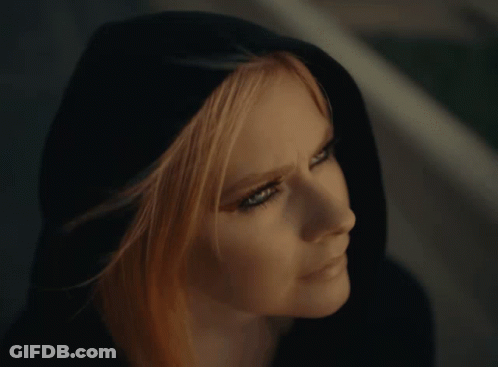 A Close Up Of A Woman 'S Face Wearing A Black Hood GIF