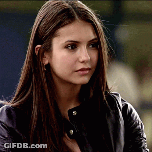 A Close Up Of A Woman 'S Face Wearing A Black Leather Jacket GIF