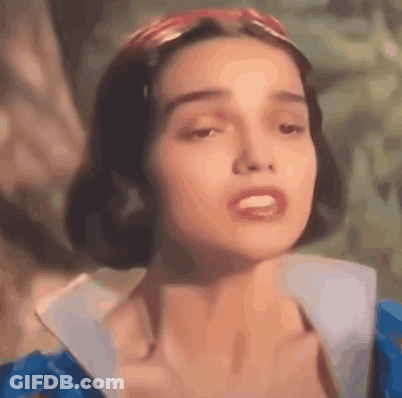 A Close Up Of A Woman 'S Face Wearing A Blue Dress And A Red Headband . GIF