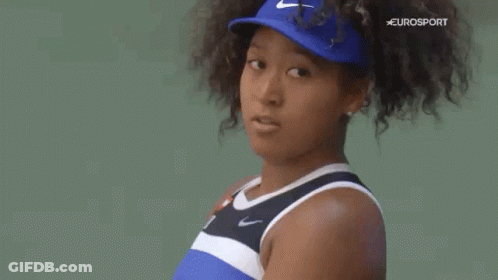 A Close Up Of A Woman 'S Face Wearing A Blue Hat . GIF