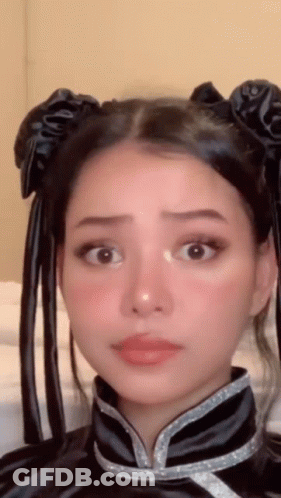 A Close Up Of A Woman 'S Face Wearing A Costume GIF