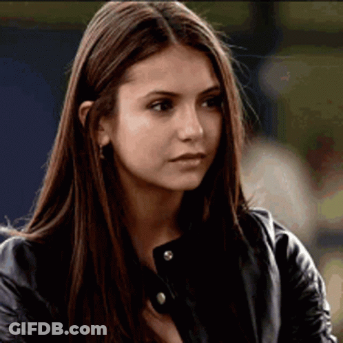 A Close Up Of A Woman 'S Face Wearing A Leather Jacket . GIF