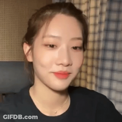 A Close Up Of A Woman 'S Face Wearing A Necklace . GIF