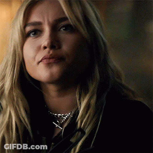 A Close Up Of A Woman 'S Face Wearing A Necklace . GIF