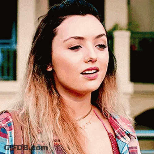 A Close Up Of A Woman 'S Face Wearing A Plaid Shirt And A Choker . GIF