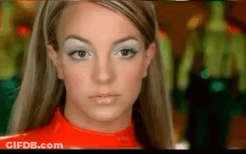A Close Up Of A Woman 'S Face Wearing A Red Top And White Eye Shadow . GIF