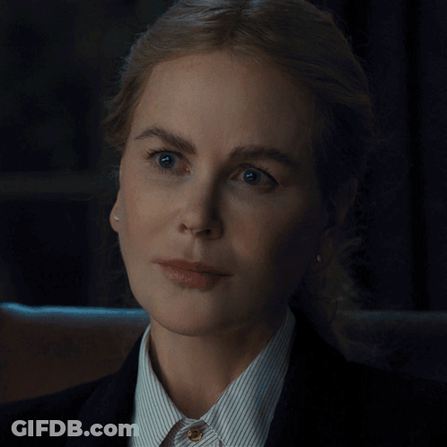 A Close Up Of A Woman 'S Face Wearing A Striped Shirt And A Black Jacket GIF