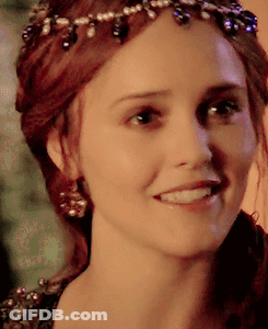 A Close Up Of A Woman 'S Face Wearing A Tiara And Smiling GIF