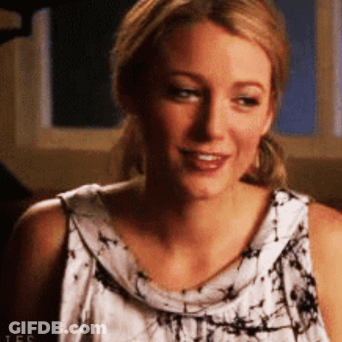 A Close Up Of A Woman 'S Face Wearing A Tie Dye Tank Top . GIF