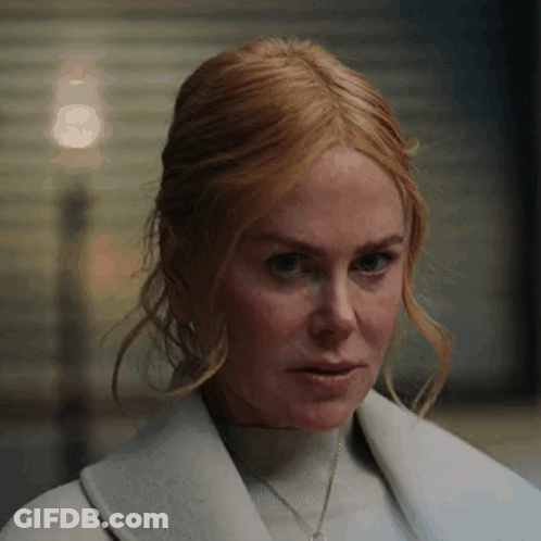 A Close Up Of A Woman 'S Face Wearing A White Coat . GIF