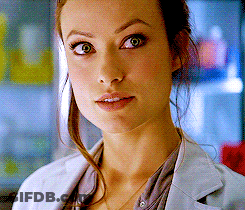 A Close Up Of A Woman 'S Face Wearing A White Jacket GIF