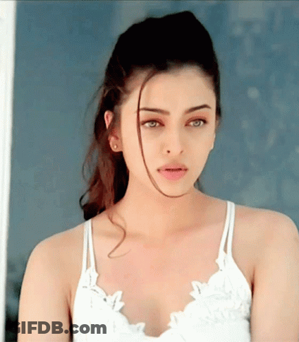 A Close Up Of A Woman 'S Face Wearing A White Top GIF