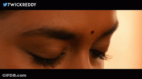 A Close Up Of A Woman 'S Face With 7Wickreddy In The Upper Right Corner GIF