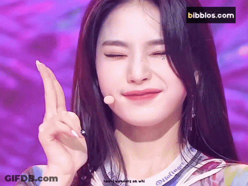 A Close Up Of A Woman 'S Face With A Bibbios.com Logo In The Background GIF