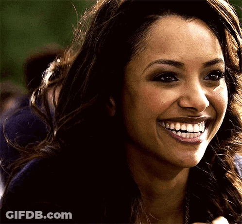 A Close Up Of A Woman 'S Face With A Big Smile On Her Face GIF