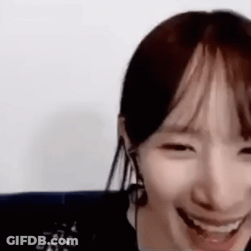A Close Up Of A Woman 'S Face With A Big Smile On Her Face . GIF