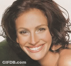 A Close Up Of A Woman 'S Face With A Big Smile GIF