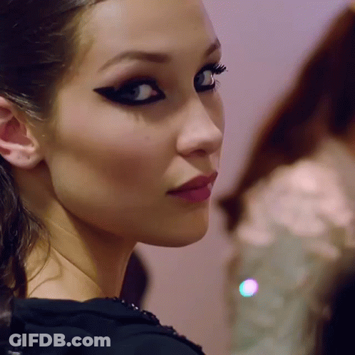 A Close Up Of A Woman 'S Face With A Black Eye Shadow GIF