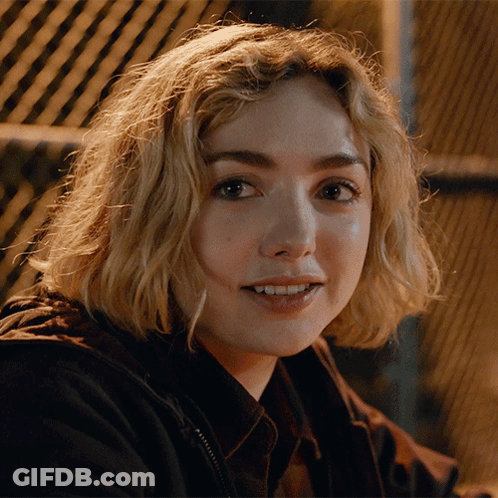 A Close Up Of A Woman 'S Face With A Black Jacket On GIF