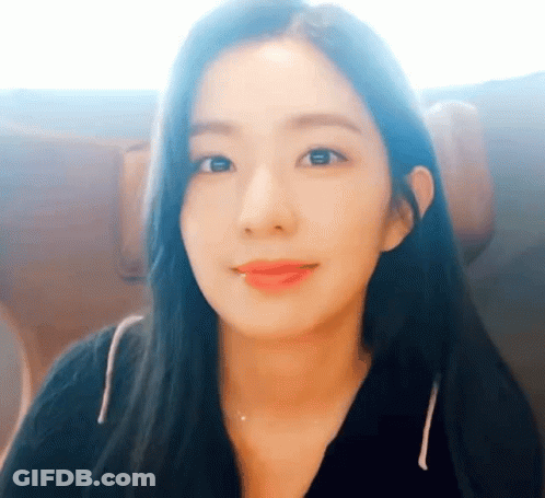 A Close Up Of A Woman 'S Face With A Black Shirt On GIF
