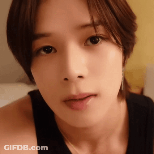 A Close Up Of A Woman 'S Face With A Black Shirt On GIF