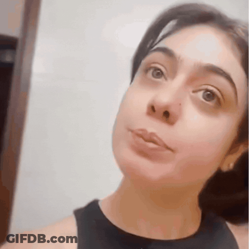 A Close Up Of A Woman 'S Face With A Black Tank Top GIF