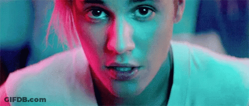 A Close Up Of A Woman 'S Face With A Blue And Red Background . GIF