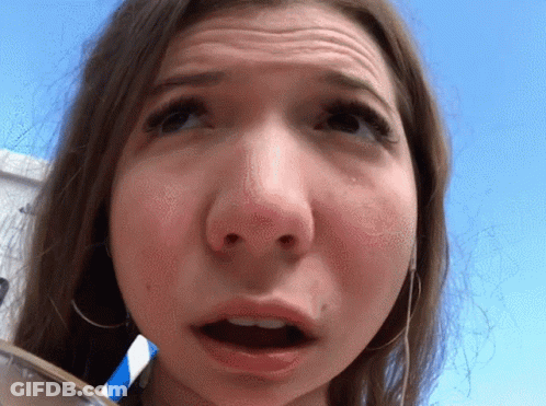 A Close Up Of A Woman 'S Face With A Blue And White Straw In Her Mouth GIF