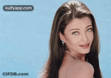 A Close Up Of A Woman 'S Face With A Blue Background . GIF
