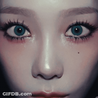 A Close Up Of A Woman 'S Face With A Blue Eye GIF