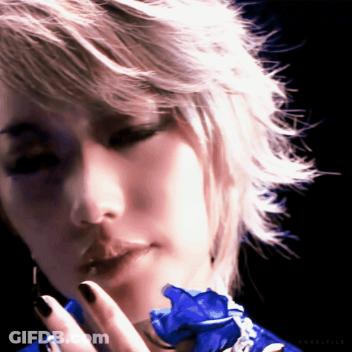 A Close Up Of A Woman 'S Face With A Blue Flower In Her Hand And The Word Eclectic On The Bottom GIF
