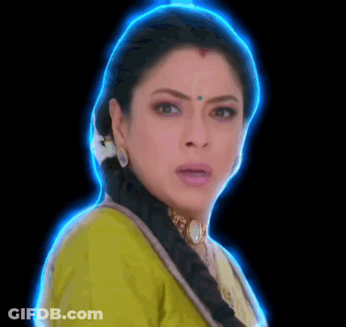 A Close Up Of A Woman 'S Face With A Blue Glow Around Her Head . GIF