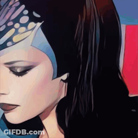A Close Up Of A Woman 'S Face With A Blue Headpiece On GIF