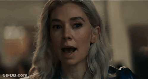 A Close Up Of A Woman 'S Face With A Blue Shirt On GIF
