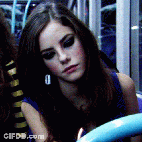 A Close Up Of A Woman 'S Face With A Blue Shirt On GIF