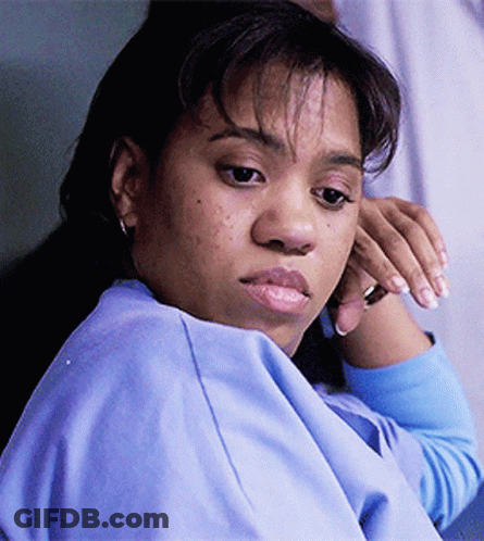 A Close Up Of A Woman 'S Face With A Blue Shirt On GIF