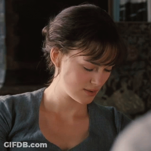 A Close Up Of A Woman 'S Face With A Blue Shirt On GIF