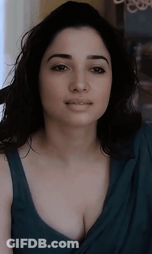 A Close Up Of A Woman 'S Face With A Blue Top On GIF