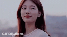 A Close Up Of A Woman 'S Face With A Blurred Background GIF
