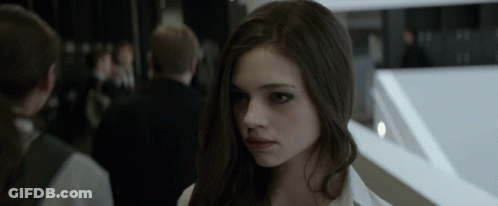 A Close Up Of A Woman 'S Face With A Blurred Background GIF