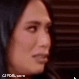 A Close Up Of A Woman 'S Face With A Blurred Background GIF