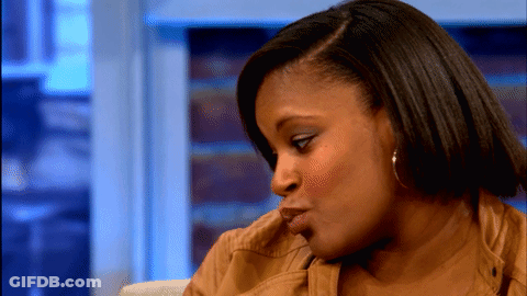 A Close Up Of A Woman 'S Face With A Blurred Background GIF