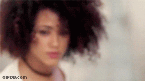 A Close Up Of A Woman 'S Face With A Blurred Background And A Choker . GIF