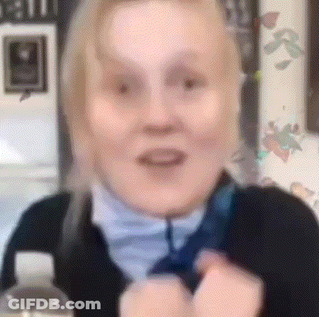 A Close Up Of A Woman 'S Face With A Blurred Background GIF