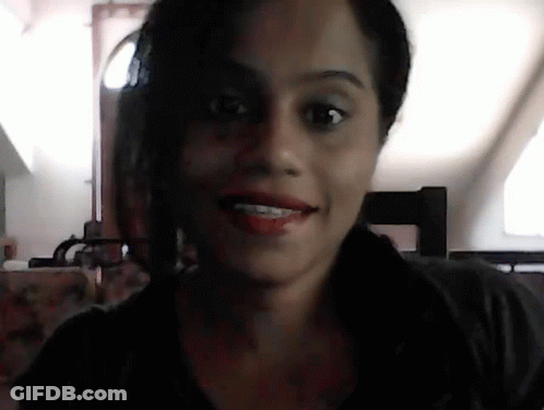 A Close Up Of A Woman 'S Face With A Blurred Background GIF