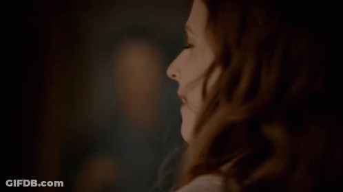 A Close Up Of A Woman 'S Face With A Blurred Background GIF