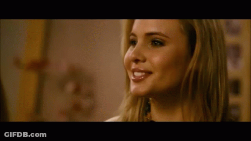 A Close Up Of A Woman 'S Face With A Blurred Background GIF
