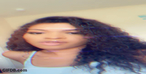 A Close Up Of A Woman 'S Face With A Blurred Background GIF