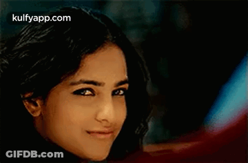 A Close Up Of A Woman 'S Face With A Blurred Background . GIF